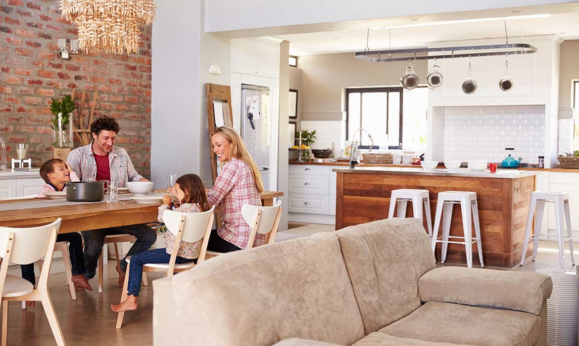 Family enjoying dinner in a large kitchen dining room