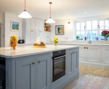 Large shaker kitchen with centre island by Chiddingfold Kitchens