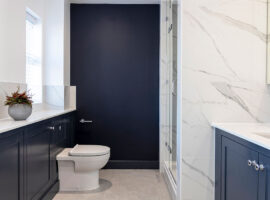 Large ensuite bathroom with bespoke indigo blue shaker cabinets by Chiddingfold Kitchens